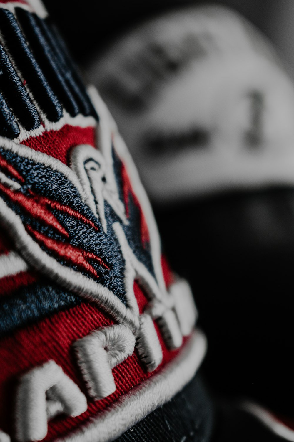 Close-up of a raised embroidered logo on a baseball cap